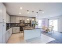 Open-concept kitchen featuring a granite island, stainless appliances, and stylish cabinetry at 412 Horsetail Falls St, Indian Springs, NV 89018