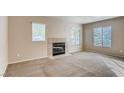 Bright living room with a tile fireplace and large windows at 447 Temple Canyon Pl, Henderson, NV 89074