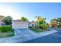 Inviting home showcasing a well-kept lawn, mature palm trees, and a spacious driveway leading to a two car garage at 4517 Inez Dr, Las Vegas, NV 89130