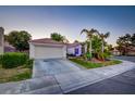 Attractive house with palm trees, green grass, and a two-car garage providing curb appeal at 4517 Inez Dr, Las Vegas, NV 89130