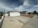 Single story home with a two car garage, ample driveway space and adjacent yard at 5324 Holmby Ave, Las Vegas, NV 89146