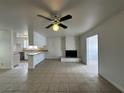 Living room with fireplace, tile floor, ceiling fan and eat-in kitchen at 5324 Holmby Ave, Las Vegas, NV 89146
