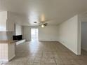 Living room with fireplace, tile floor, ceiling fan and open space at 5324 Holmby Ave, Las Vegas, NV 89146