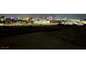 Night view of the distant Las Vegas skyline from a desert lot at 5770 El Camino Rd, Las Vegas, NV 89118