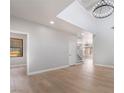 Bright open-plan living room featuring high ceilings and modern hardwood floors at 6405 Strongbow Dr, Las Vegas, NV 89156