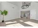 Spacious living room with high ceilings, wood-style flooring, a modern fireplace and sliding glass doors at 6509 Old Oxford Ave, Las Vegas, NV 89108