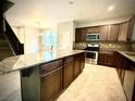 Open kitchen featuring granite countertops, stainless steel appliances, and tile flooring at 6639 Ivory Dove Ct, Las Vegas, NV 89148