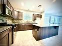 Modern kitchen with granite countertops, stainless steel appliances, and a large center island at 6639 Ivory Dove Ct, Las Vegas, NV 89148