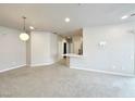 Carpeted living room featuring neutral tones, recessed lighting, and an open floor plan at 6868 Sky Pointe Dr # 2013, Las Vegas, NV 89131