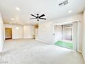 Open-concept living room with carpet, recessed lights, and a sliding glass door to the outdoors at 6868 Sky Pointe Dr # 2013, Las Vegas, NV 89131