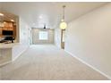 Bright living room featuring carpet floors, a ceiling fan, recessed lighting, and an open-concept layout at 6868 Sky Pointe Dr # 2013, Las Vegas, NV 89131