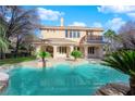 A large private pool surrounded by mature landscaping offers a resort-like experience at 807 Canyon Greens Dr, Las Vegas, NV 89144