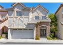 Charming two-story home with Tudor-style accents, a front porch, and a two-car garage at 9228 Whitekirk Pl, Las Vegas, NV 89145
