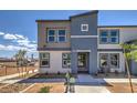Modern townhouse with a two-tone color scheme, landscaped front yard, and clear property number display at 9403 Jade Mesa St # 40, Las Vegas, NV 89139