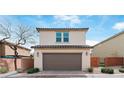 Two-story home with attached garage, desert landscaping, and brick surround at 10943 Ketchikan St, Las Vegas, NV 89179