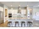 Bright kitchen with white cabinetry, stainless steel appliances, granite countertops, and a center island with seating at 11137 Black Fire Opal Dr, Las Vegas, NV 89138