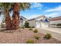 Charming single-Gathering home with a large three car garage, a manicured yard and a beautiful palm tree at 182 Horizon View Dr, Henderson, NV 89015