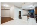 Open-concept living space featuring tile floors leading to a kitchen with dark wood floors and city views at 200 W Sahara Ave # 1810, Las Vegas, NV 89102
