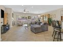 Spacious living room with tile flooring, fireplace, large windows, and comfortable seating arrangement at 2156 Shadow Canyon Dr, Henderson, NV 89044
