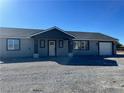 Charming single-story home featuring a gray exterior and a well-maintained front yard at 220 N David St, Pahrump, NV 89060