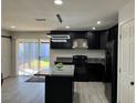 Modern kitchen featuring dark cabinetry, an island with countertop, and stainless steel appliances at 2820 Richfield Blvd, Las Vegas, NV 89102