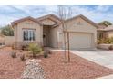 Single-story home with a two-car garage, desert landscaping, and neutral stucco exterior at 3239 Robins Creek Pl, Las Vegas, NV 89135