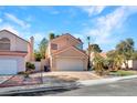Charming home featuring a two-car garage and desert landscaping at 3257 Coral Harbor Dr, Las Vegas, NV 89117