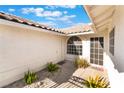Inviting entrance with a tiled roof and cozy welcome mat at 3517 S Dapple Gray Rd, Las Vegas, NV 89147