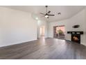 Spacious living room featuring a fireplace, ceiling fan, and sliding glass doors to the backyard at 3517 S Dapple Gray Rd, Las Vegas, NV 89147