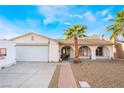 Charming single-story home featuring a two car garage and desert landscaping with mature palms at 3661 Margarita Way, Las Vegas, NV 89103