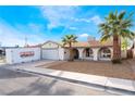 Charming single-story home featuring a two car garage and desert landscaping with mature palms at 3661 Margarita Way, Las Vegas, NV 89103