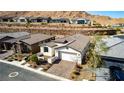 Lovely single-story home with a brick driveway, beautiful landscaping, and attached garage at 59 Desert Ivy Ln, Henderson, NV 89011