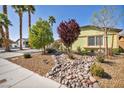 Charming single-story home featuring desert landscaping, mature trees, and a well-maintained exterior at 6520 Ouida Way, Las Vegas, NV 89108