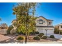Beautiful two-story home featuring a three-car garage and meticulous landscaping at 6971 Cedar Basin Ave, Las Vegas, NV 89142