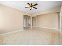Large living area features tile floors, ceiling fan and neutral wall colors at 6982 Mirkwood Ave, Las Vegas, NV 89178