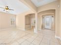 Spacious living room with tile floors, archways, ceiling fan and ample natural light at 6982 Mirkwood Ave, Las Vegas, NV 89178