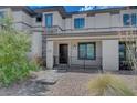 Stylish townhome exterior featuring well-kept landscaping and a covered front porch, perfect for relaxing outdoors at 757 Omaggio Pl, Henderson, NV 89011