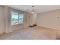 Inviting living room with large window and neutral carpet, offering a comfortable and versatile living space at 757 Omaggio Pl, Henderson, NV 89011