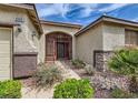 Inviting front entrance features a secured gate, desert landscaping, and a well-maintained walkway to the front door at 8698 Waterford Bend St, Las Vegas, NV 89123