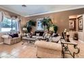 Elegant living room showcasing stylish furnishings, decorative palms, neutral tones, and natural light at 8698 Waterford Bend St, Las Vegas, NV 89123