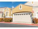Attached two-car garage with a tan door, set against a clear blue sky at 928 Collingtree St, Las Vegas, NV 89145
