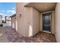 Modern home entryway featuring a black front door and paver walkway at 9283 Lunar Phase St, Las Vegas, NV 89143