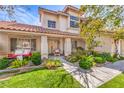 Inviting front porch with swing and well-maintained landscaping enhances the curb appeal at 1009 Nawkee Dr, North Las Vegas, NV 89031