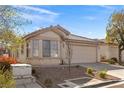Well-maintained single-story home with a tile roof, bay window, and two-car garage, set in a landscaped yard at 11076 Zampino St, Las Vegas, NV 89141