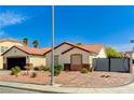 Attractive single-story home with desert landscaping, a red tile roof and gated driveway at 1110 Azure Heights Pl, Las Vegas, NV 89110