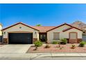Inviting single-story home features a well-manicured front yard and convenient two-car garage at 1110 Azure Heights Pl, Las Vegas, NV 89110