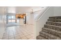Bright and airy living room features tile flooring, a staircase, and an open layout, great for entertaining at 1129 Paradise Vista Dr, Henderson, NV 89002