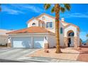 Inviting two-story home featuring a terracotta roof, desert landscaping, and a two-car garage at 1142 Teal Point Dr, Henderson, NV 89074