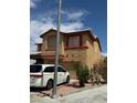 Two-story home with a two-car garage with decorative shutters at 1286 N Sloan Ln, Las Vegas, NV 89110
