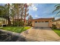 Charming single-story home featuring a well-manicured lawn and a two-car garage at 129 Chateau Whistler Ct, Las Vegas, NV 89148